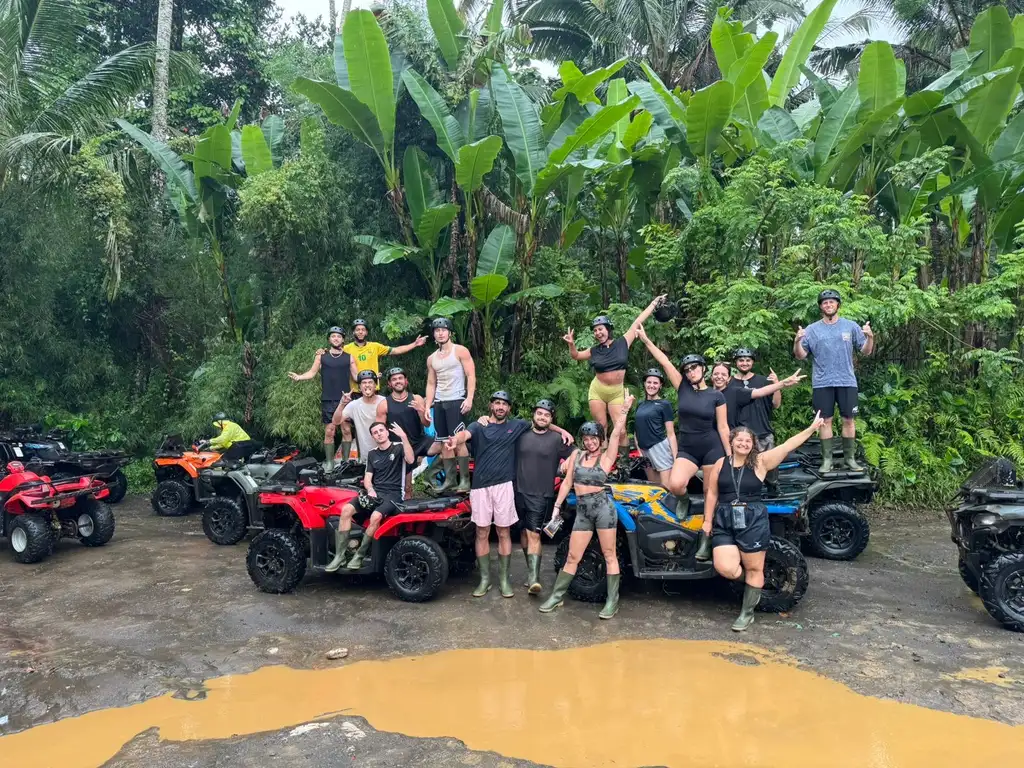 A group celebrating on their ATVs after a muddy Ubud day trip